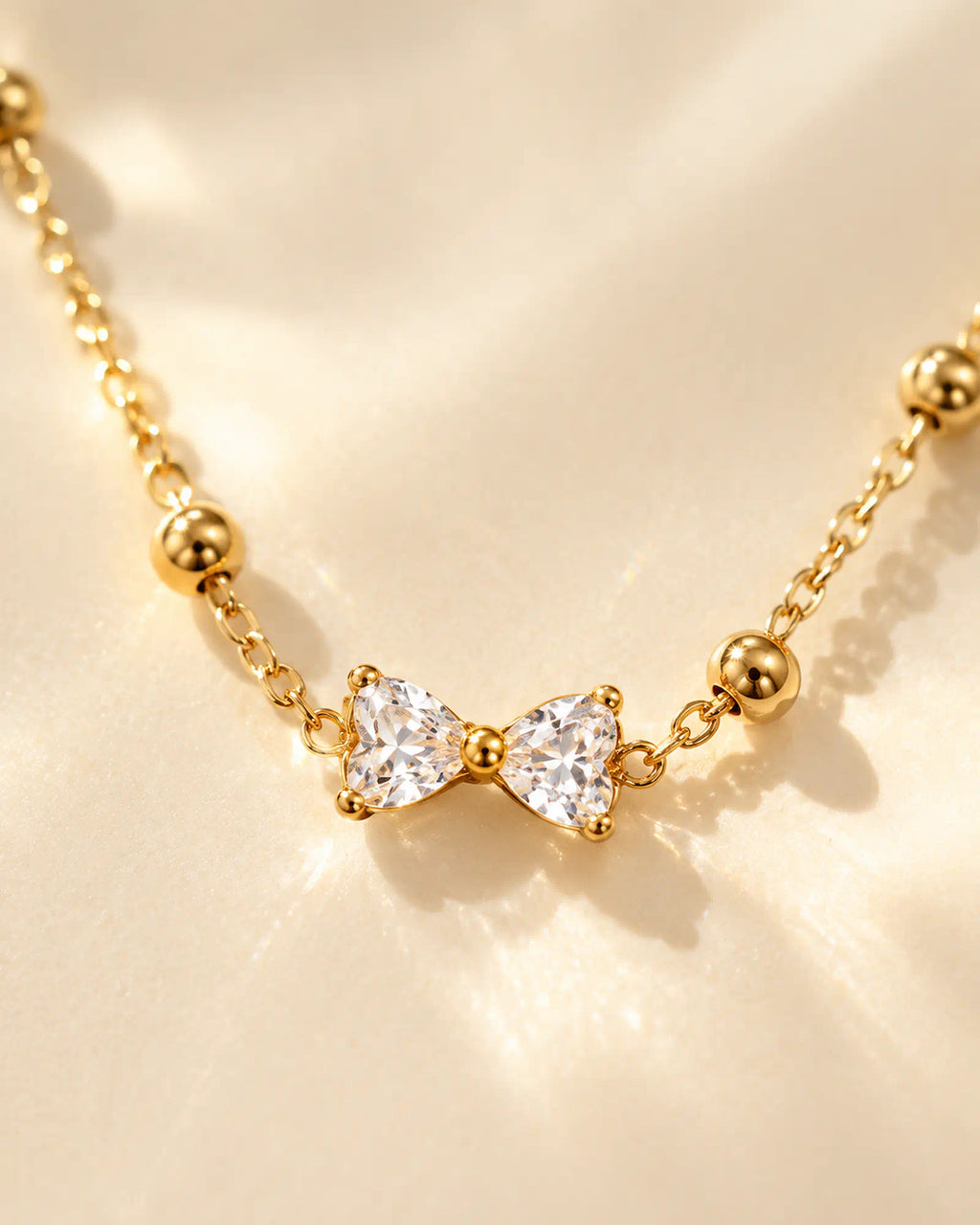 Wearlumi Beaded Bow Pendant Necklace macro detail of faceted bow centerpiece