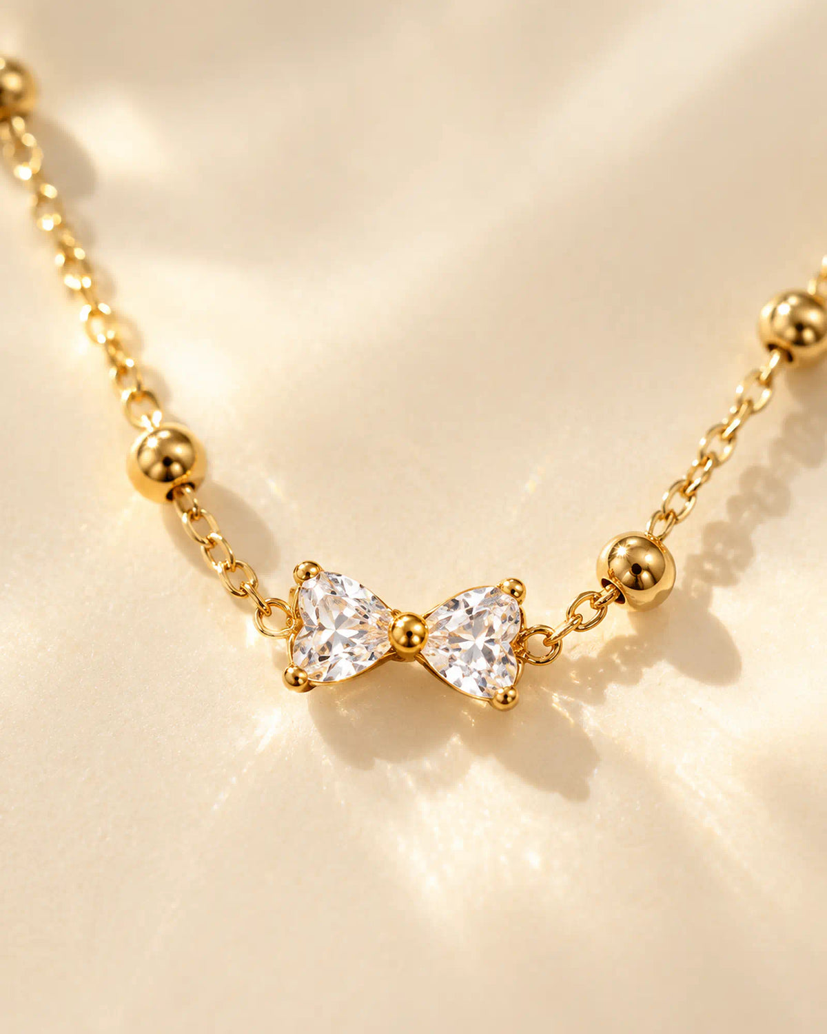Wearlumi Beaded Bow Pendant Necklace macro detail of faceted bow centerpiece