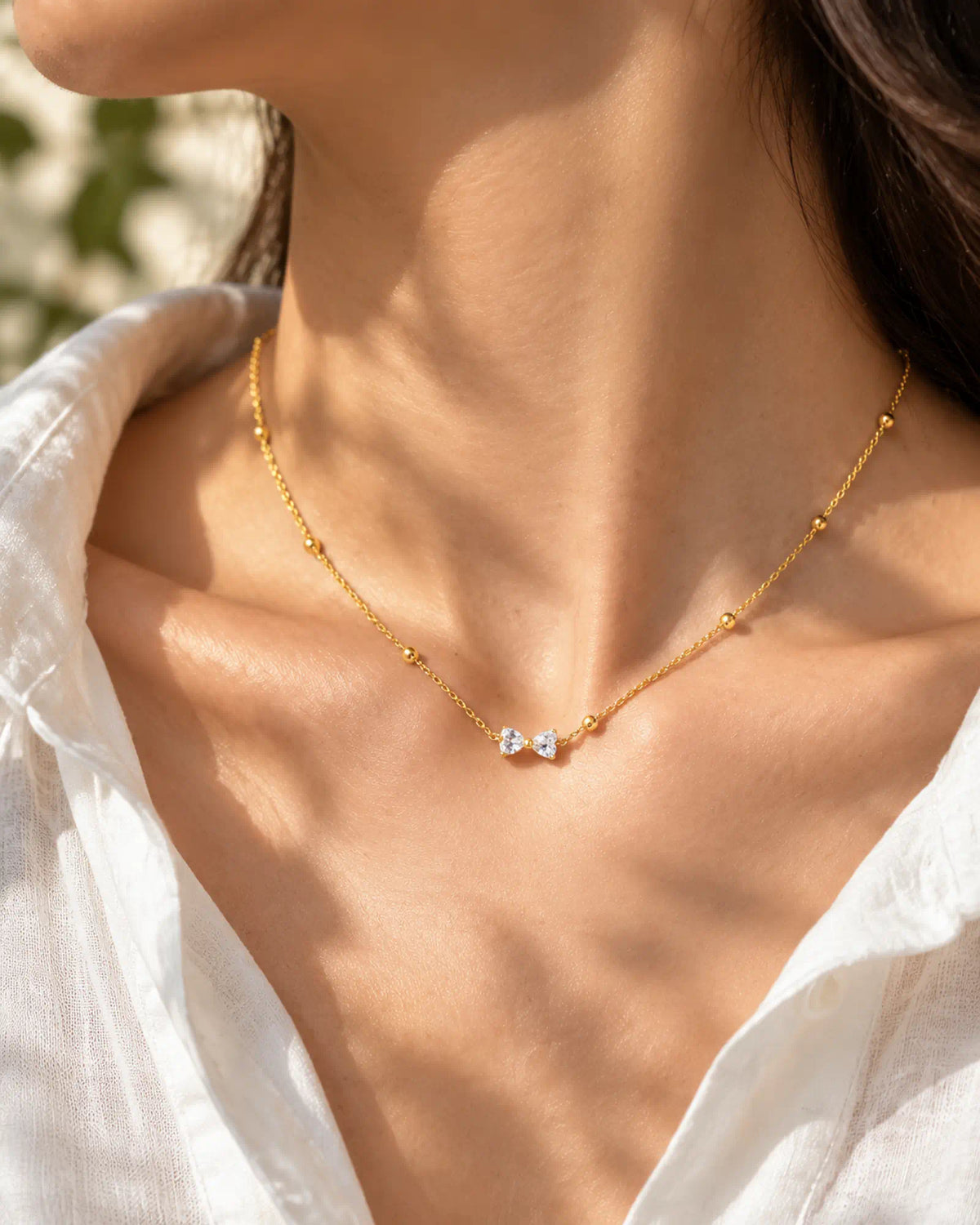 Wearlumi Beaded Bow Pendant Necklace worn close-up on collarbone