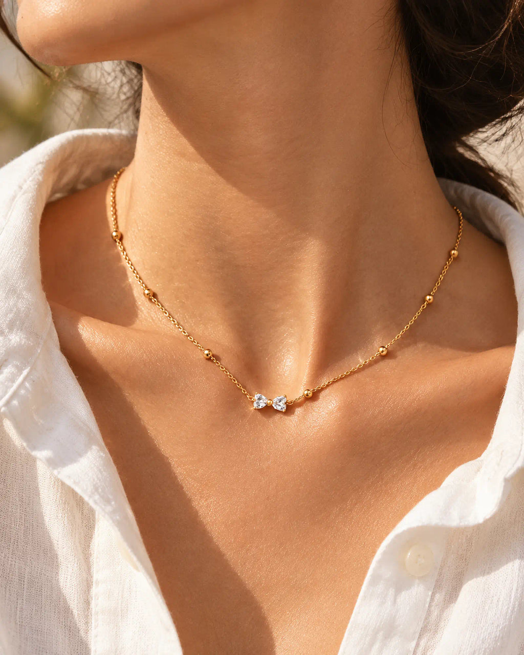 Wearlumi Beaded Bow Pendant Necklace styled with white summer shirt