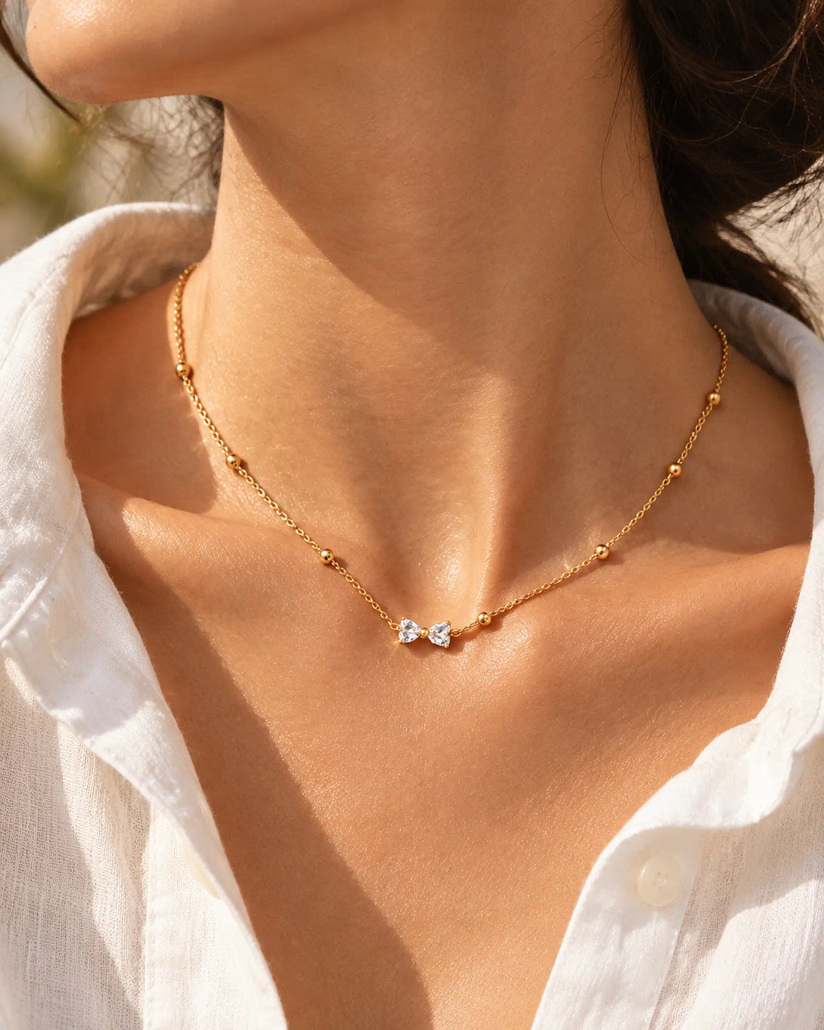 Wearlumi Beaded Bow Pendant Necklace styled with white summer shirt