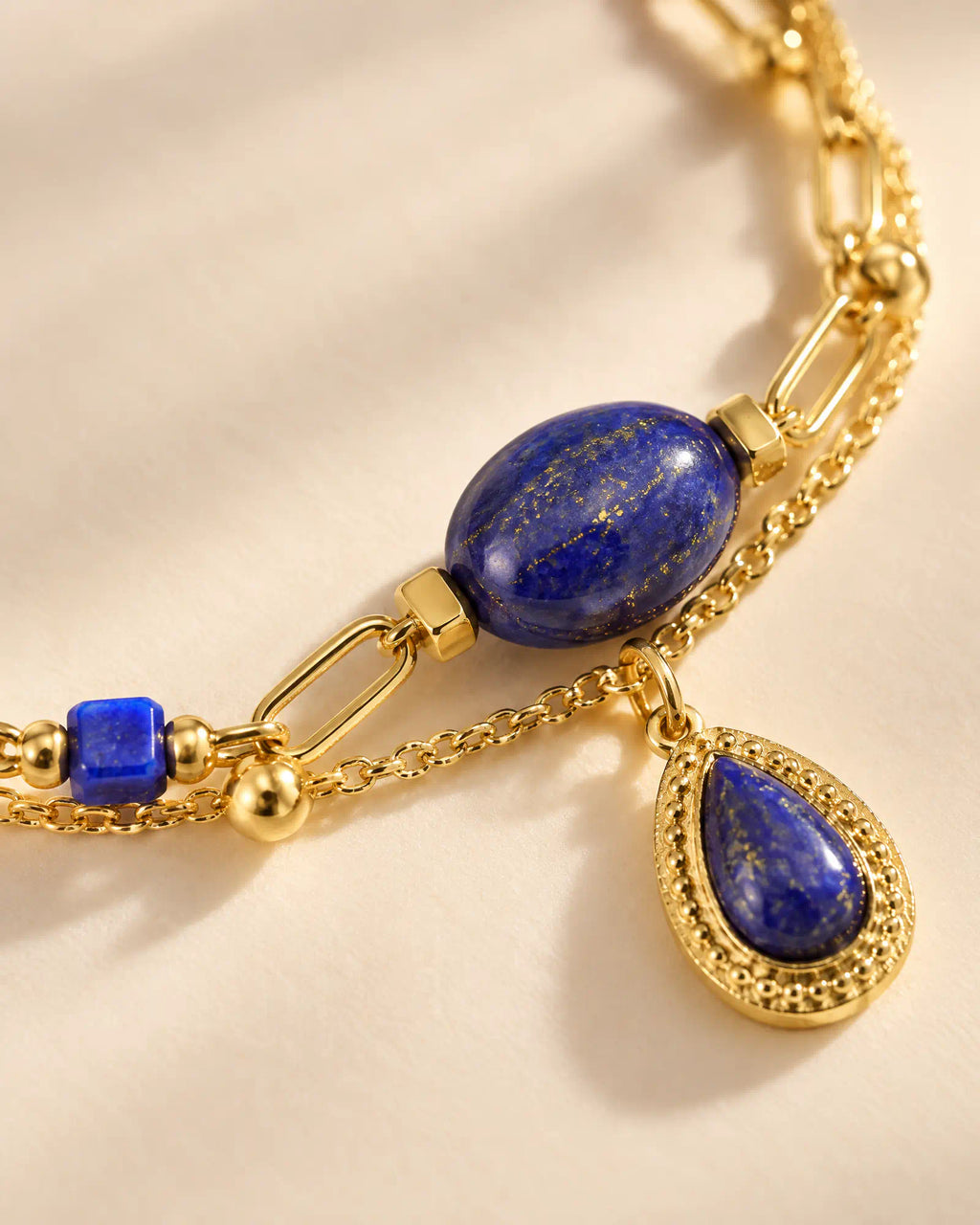 Close-up macro detail of lapis cabochon and textured teardrop bezel