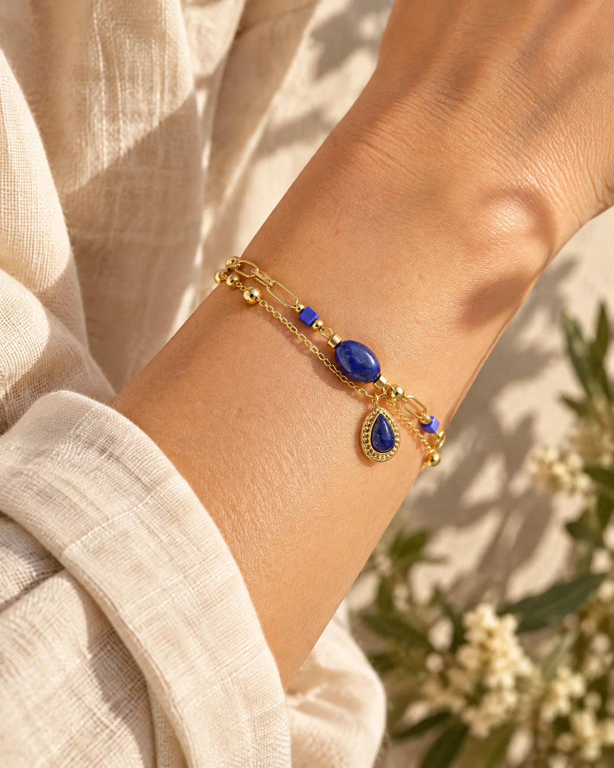 Midnight Teardrop Layered Bracelet worn on wrist against linen fabric