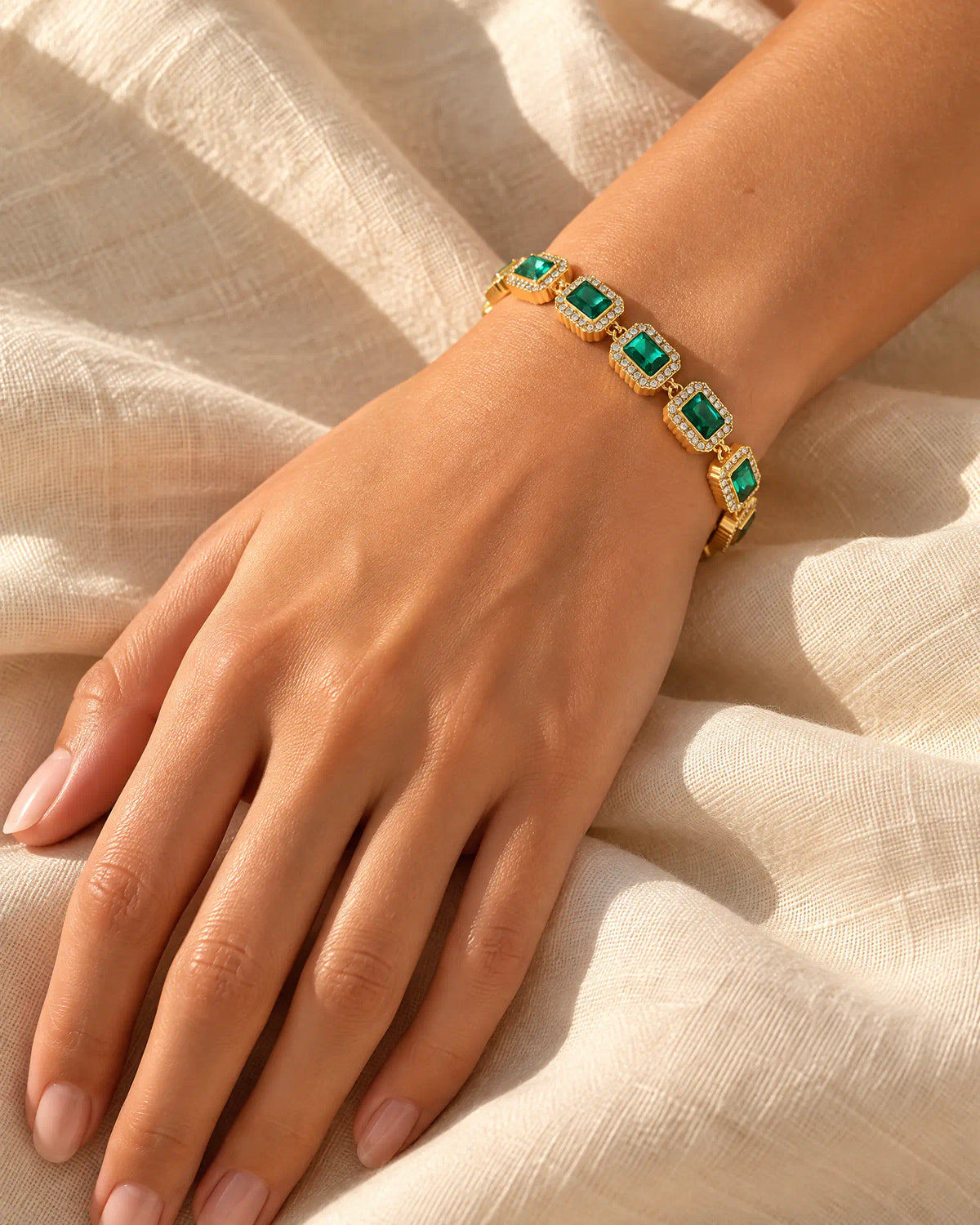 Verdant Cadence Tennis Bracelet on wrist resting on linen