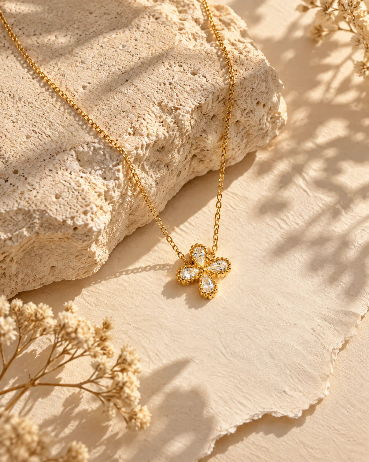 Wearlumi Four Petal Beaded Clover Pendant Necklace on natural limestone surface