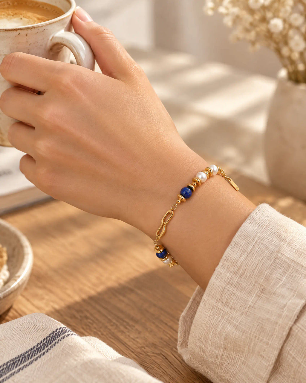 Lifestyle morning coffee scene with Fluid Wave Asymmetric Bracelet