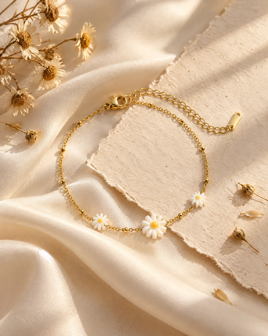 Sunlit Daisy Station Bracelet draped gracefully across cream silk fabric