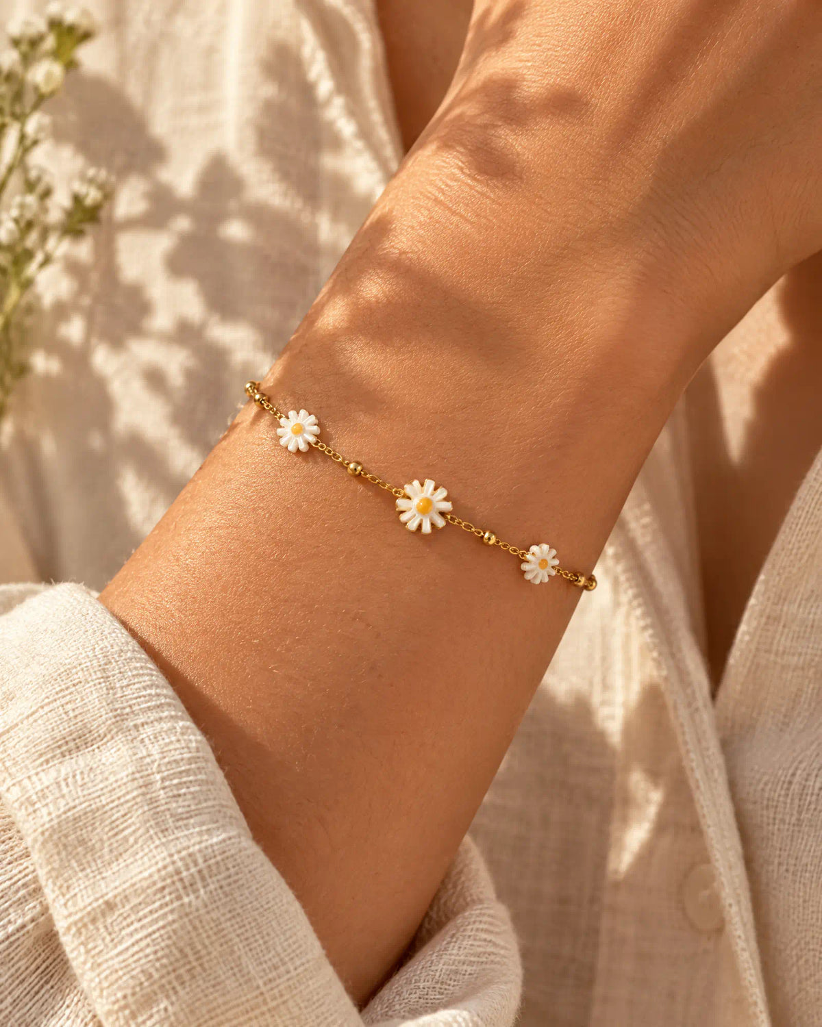 Sunlit Daisy Station Bracelet worn on wrist against linen fabric
