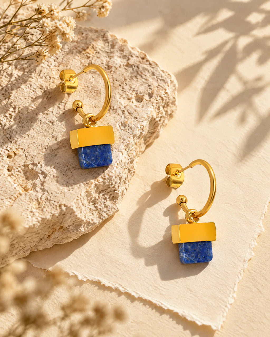 Stepped Horizon Hoop Earrings resting on natural limestone