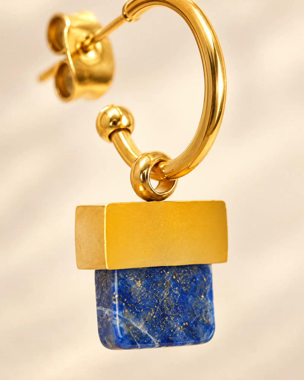 Macro detail of Stepped Horizon Hoop Earrings showing blue and ochre blocks