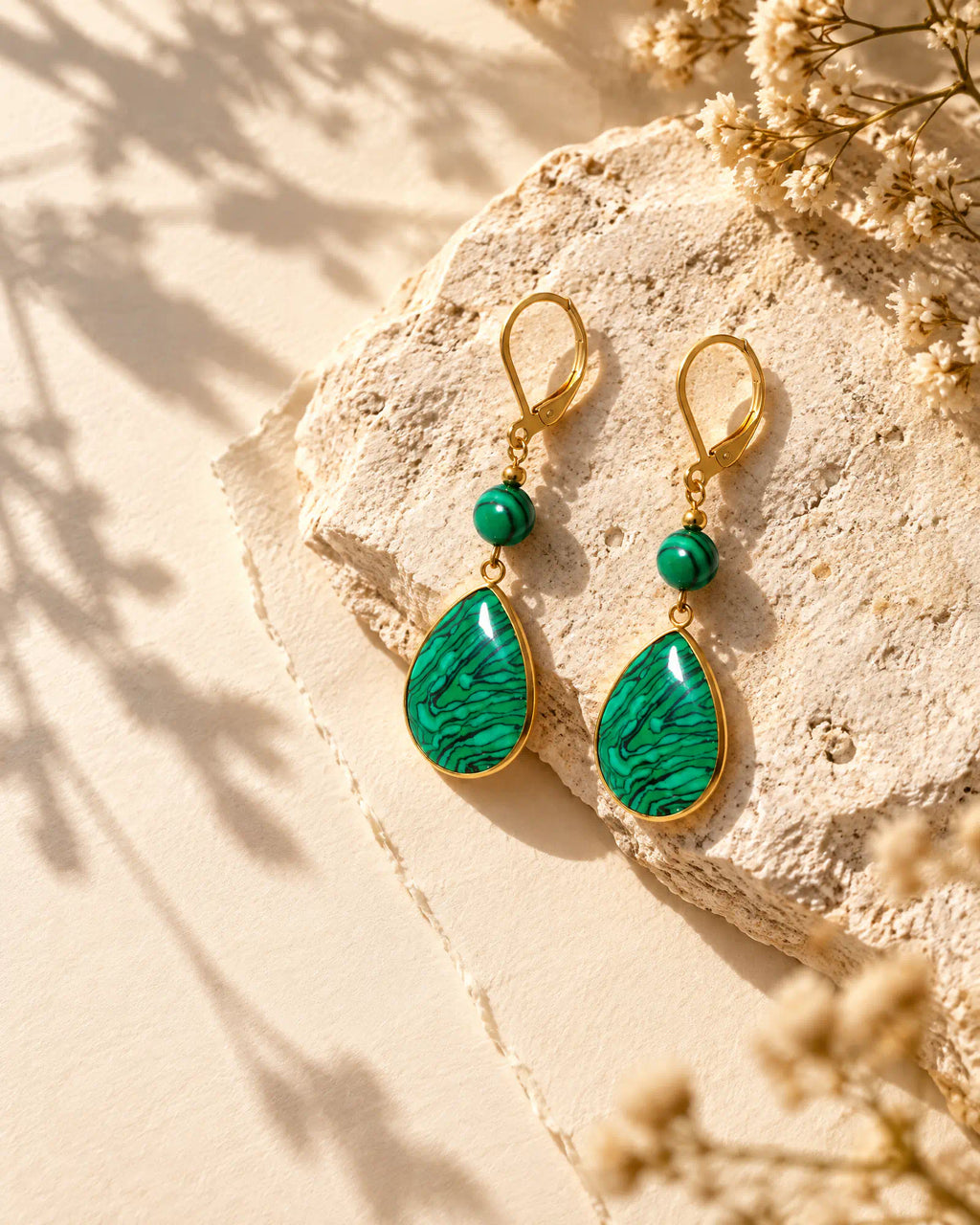 Verdant Teardrop Leverback Earrings resting on natural limestone