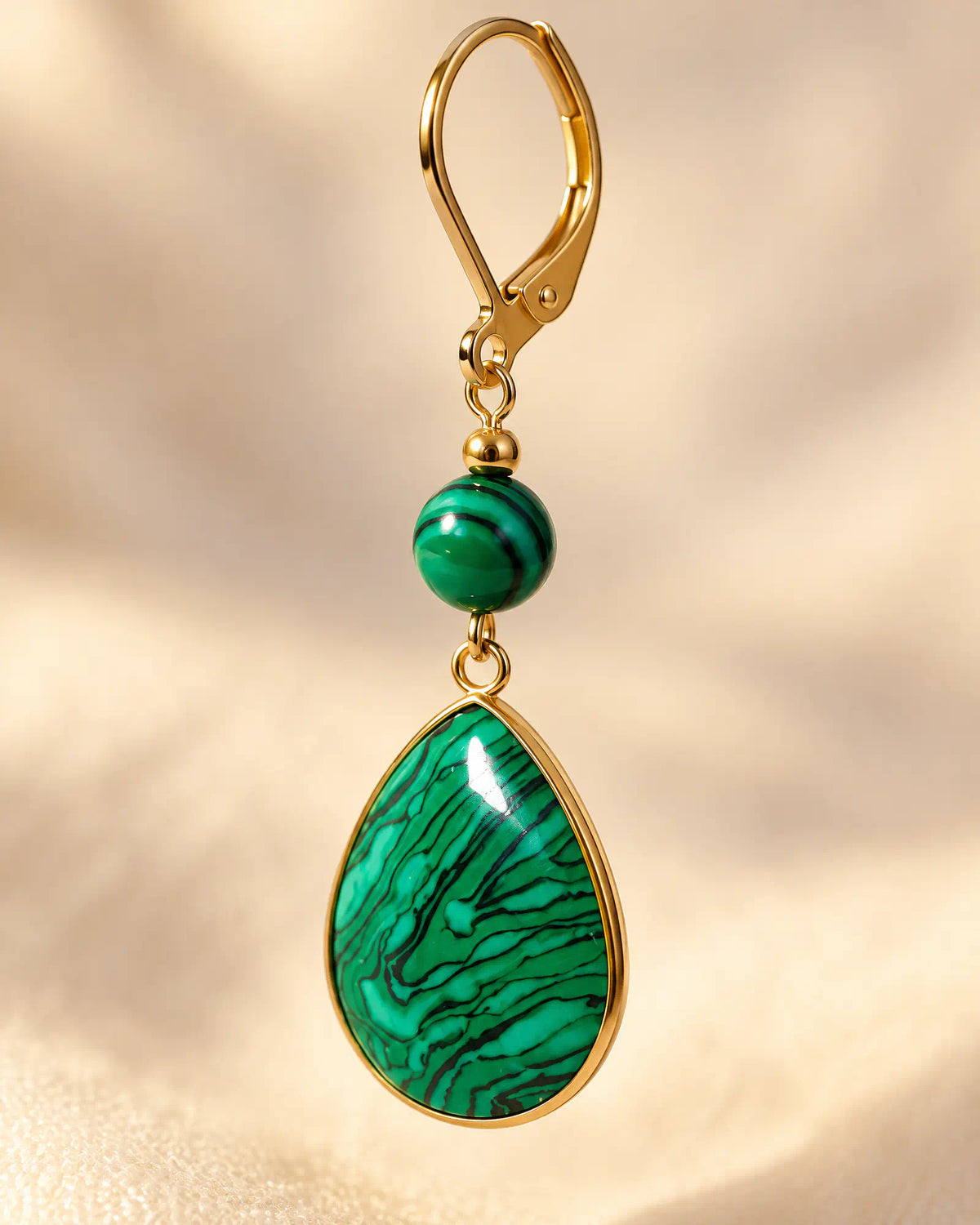 Macro detail of Verdant Teardrop Leverback Earrings showing banded malachite patterns
