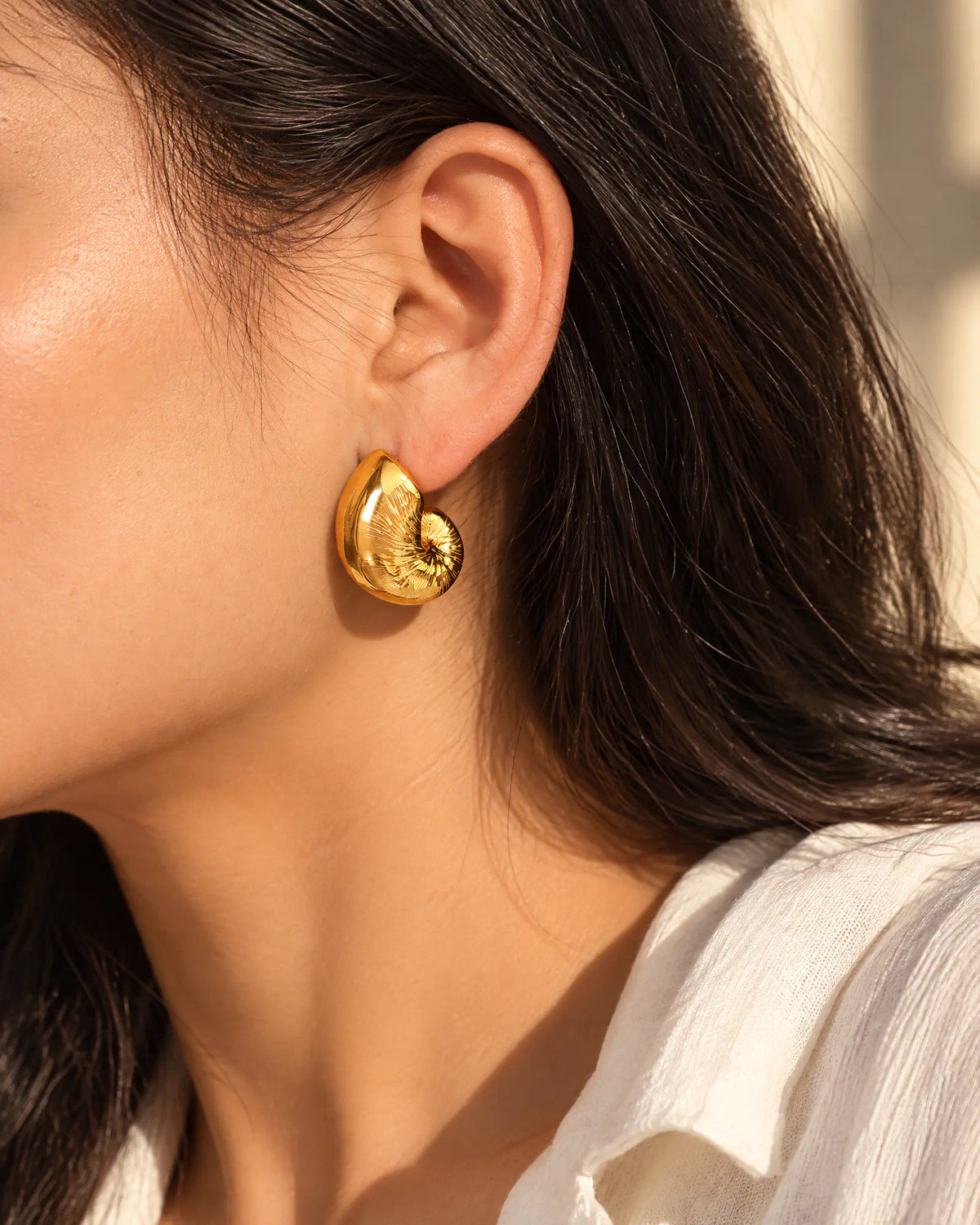 Coiled Nautilus Shell Stud three quarter ear worn view