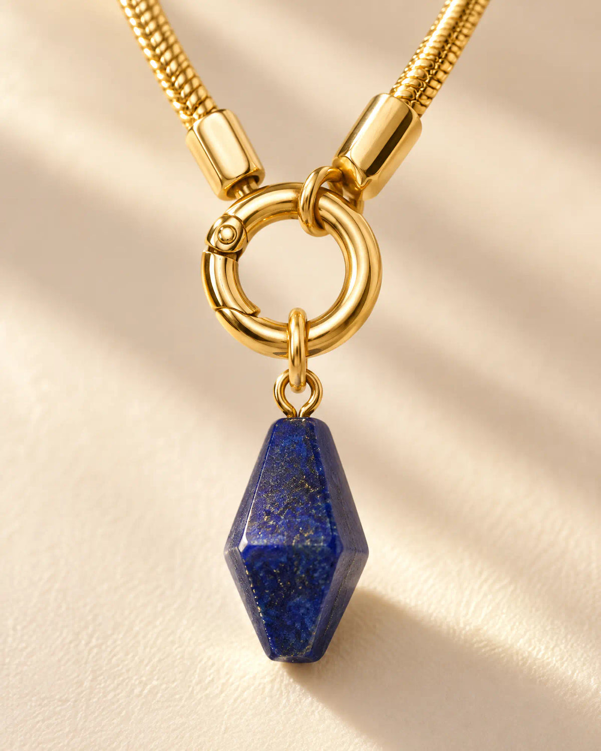Close up macro detail of front spring ring clasp and faceted lapis lazuli drop