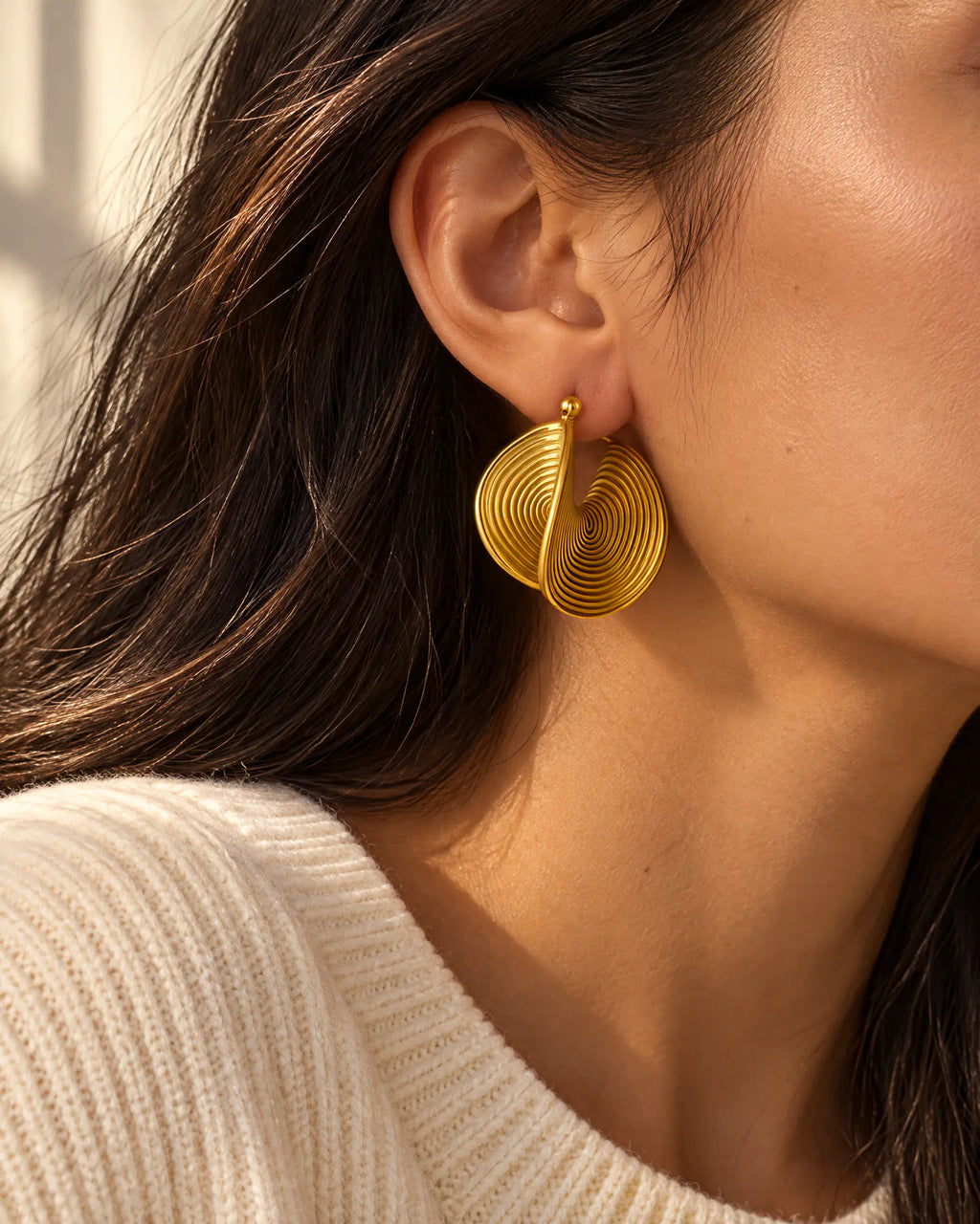 Three quarter view of Spiral Twist Statement Earrings on model