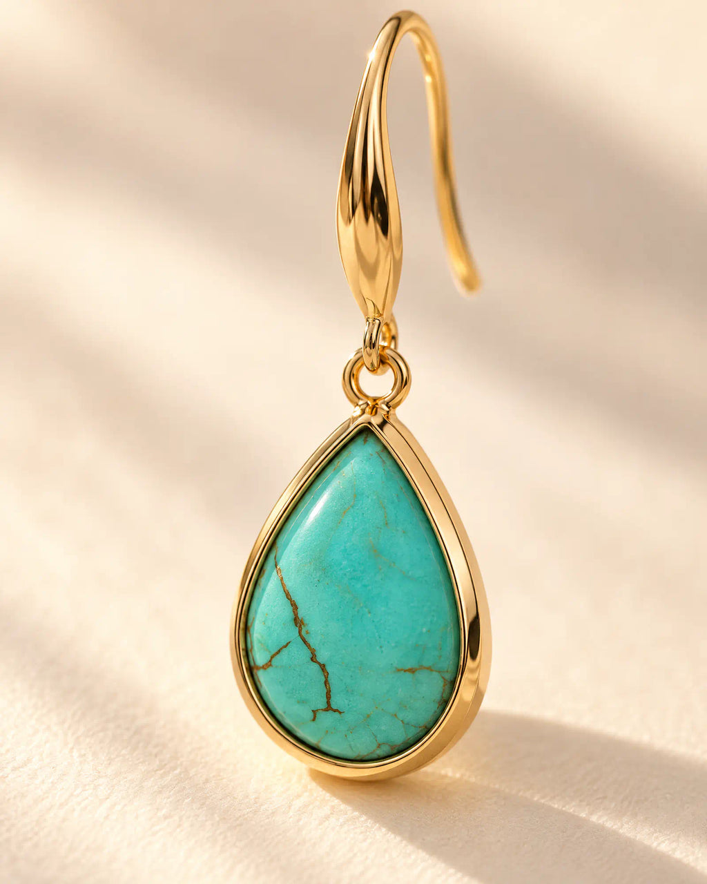 Macro detail of Coastal Teardrop Drop Earrings showing robin-egg blue cabochon and veining