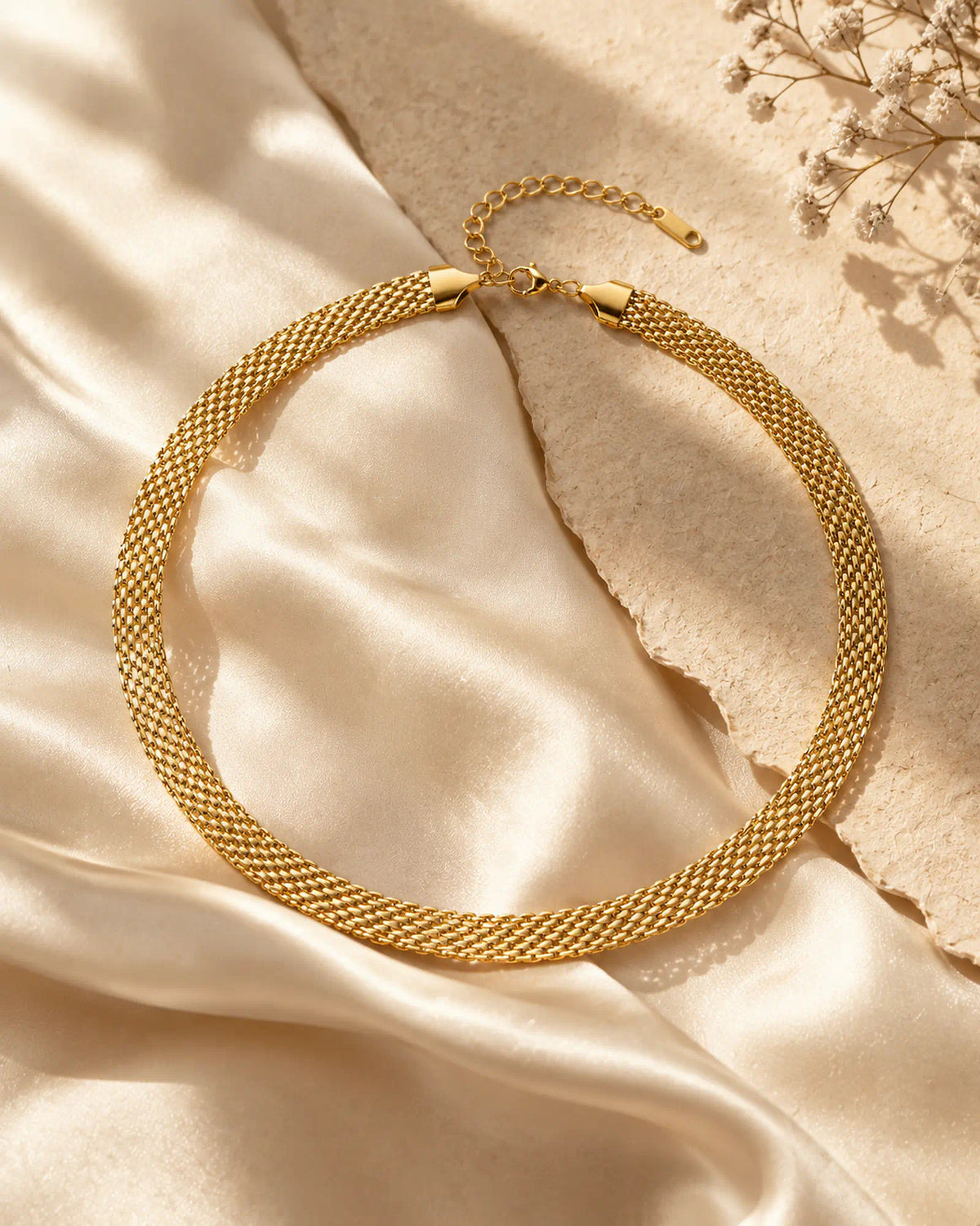 Wearlumi Woven Contour Collar Necklace draped on warm ivory silk fabric