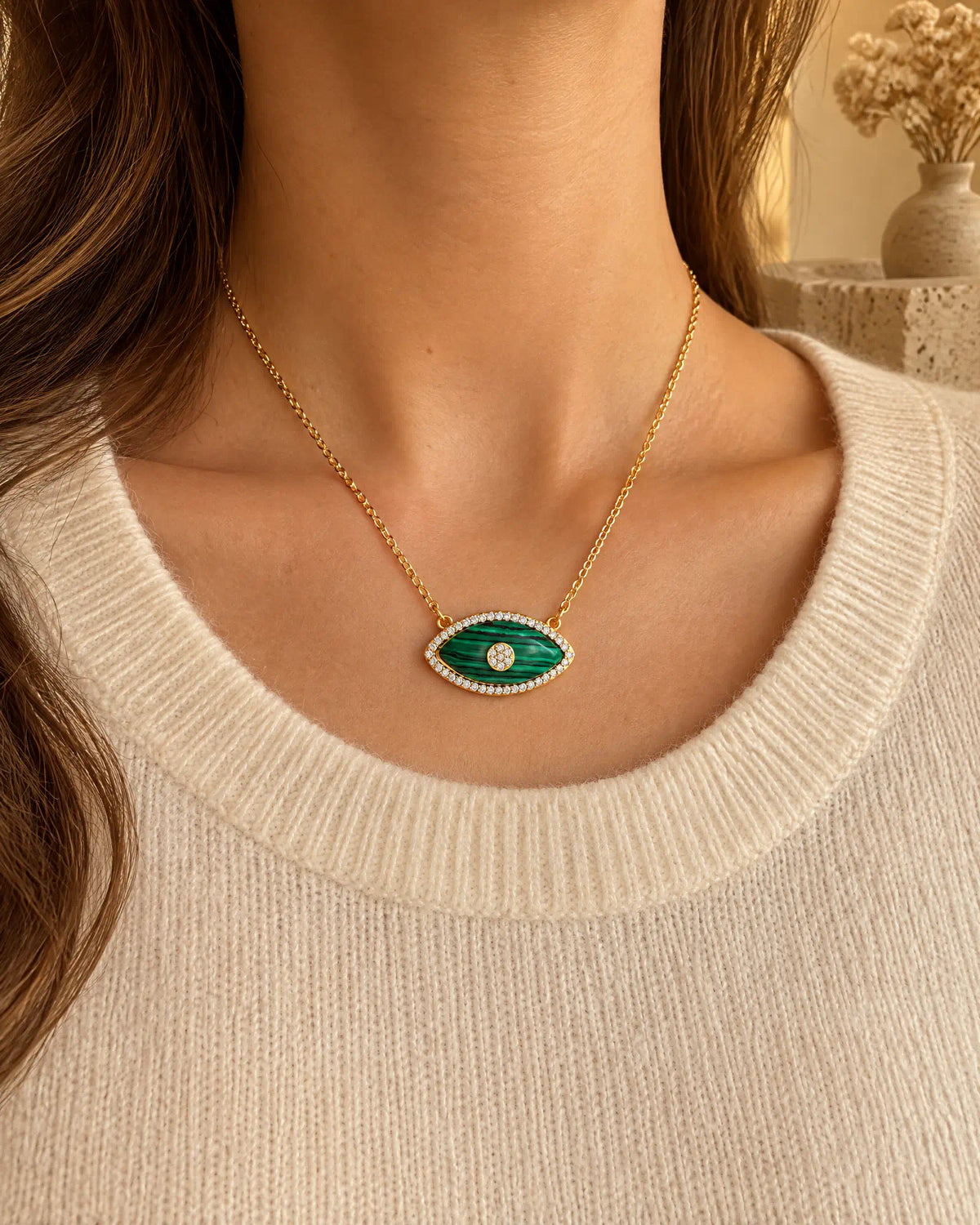 Verdant Eye Pendant worn over a cream knit sweater