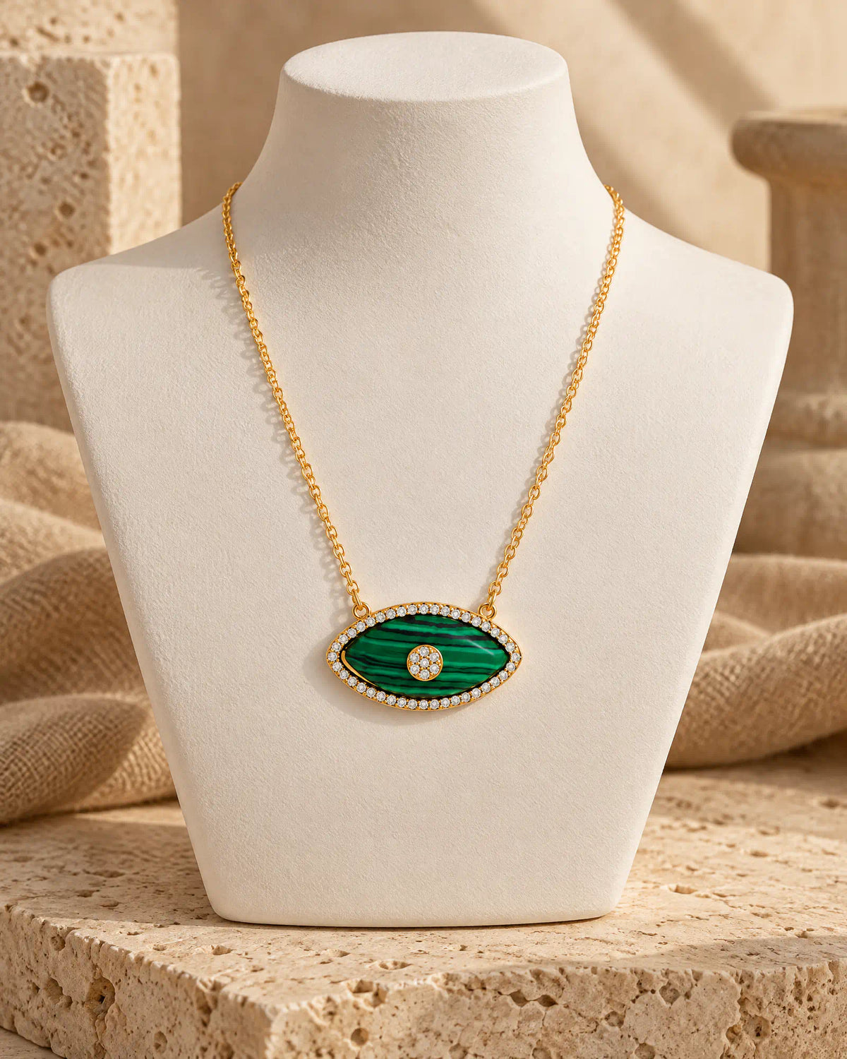 Verdant Eye Pendant styled on a cream display bust