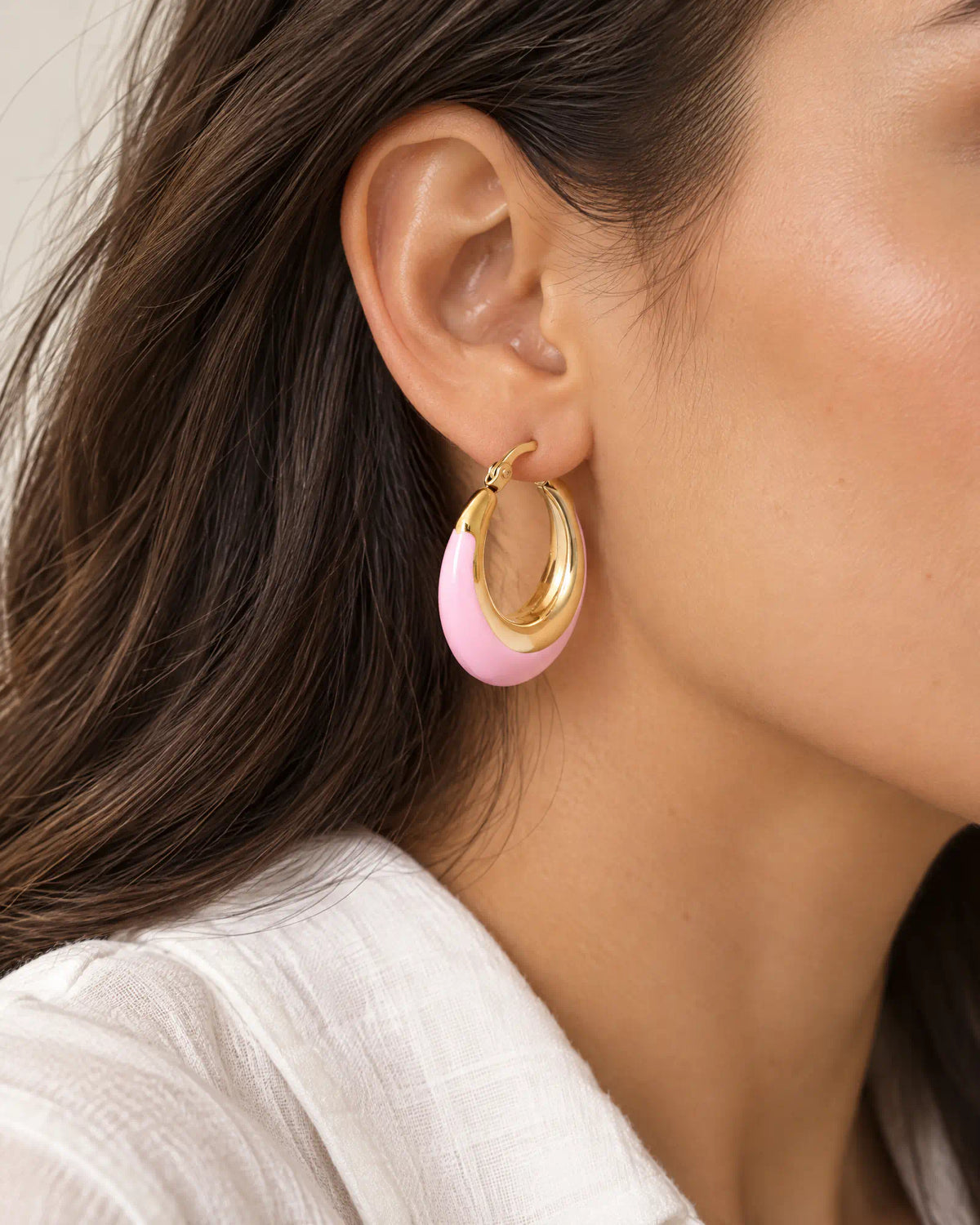 Blush Crescent Oval Hoops worn on ear