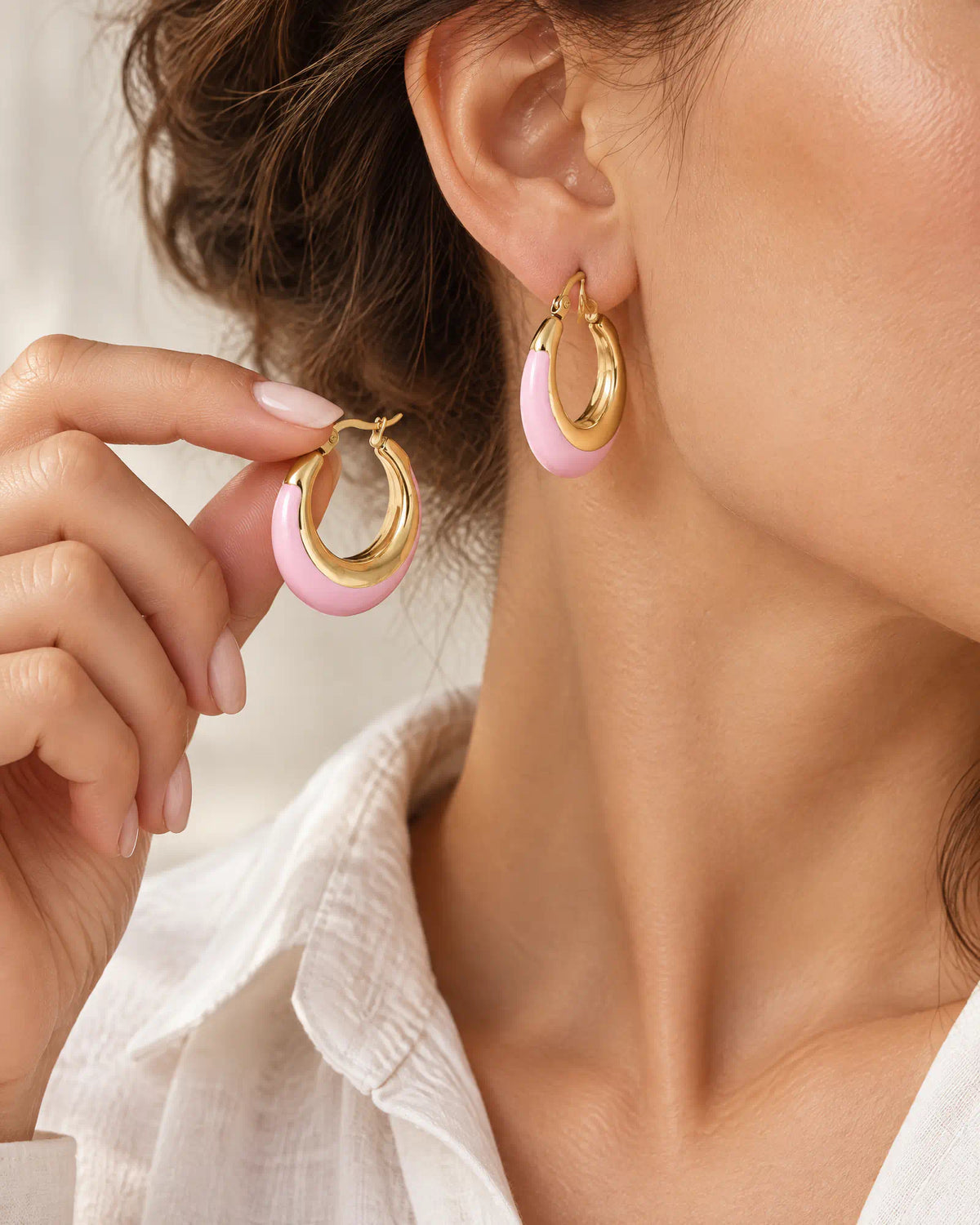 Blush Crescent Oval Hoops held in hand
