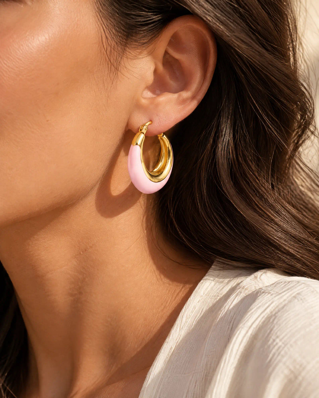 Blush Crescent Oval Hoops three-quarter profile on ear