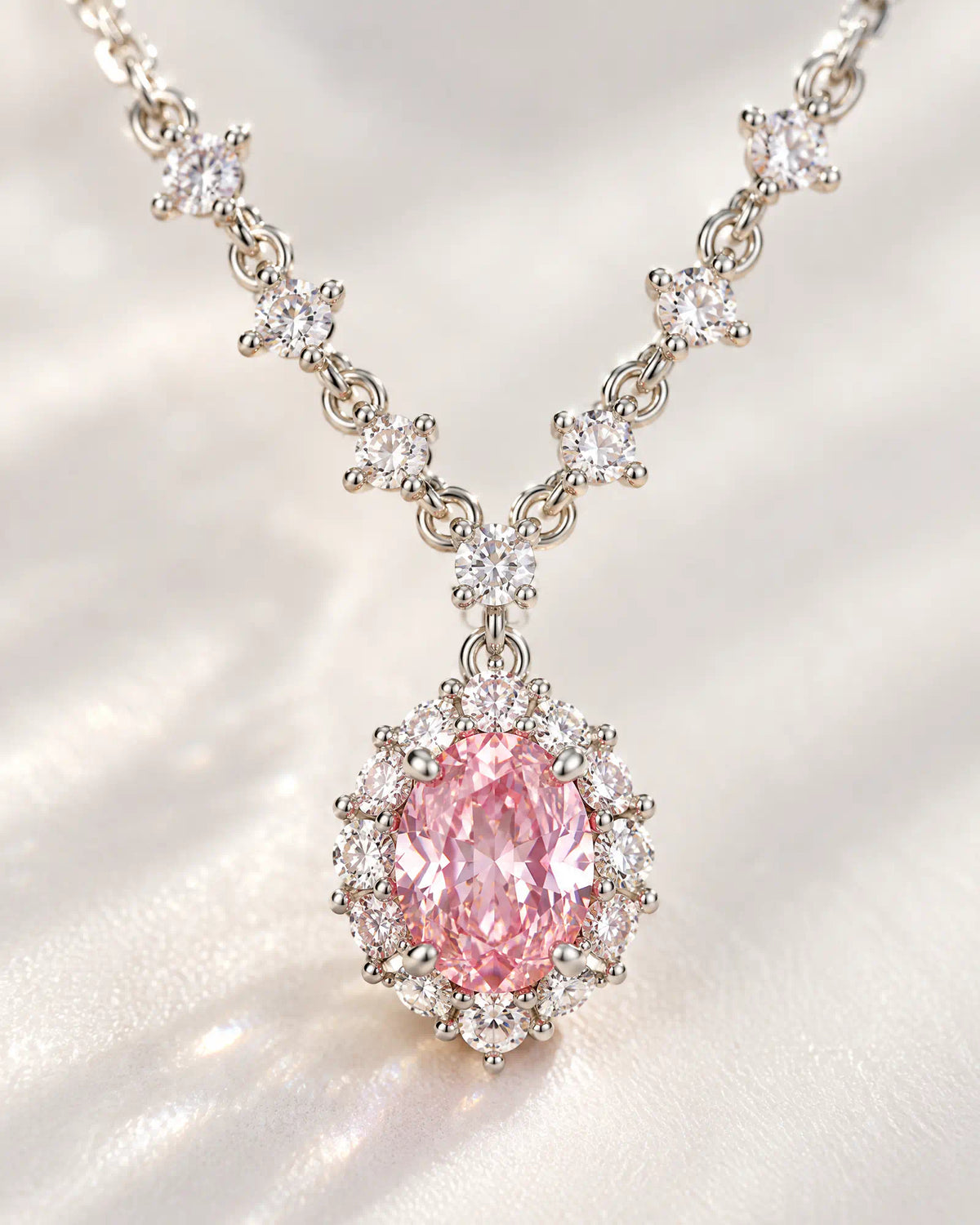 Wearlumi Blush Oval Halo Necklace macro detail of pink faceted centerpiece and halo stones