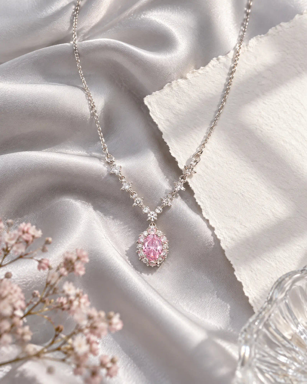 Wearlumi Blush Oval Halo Necklace draped over draped champagne silk