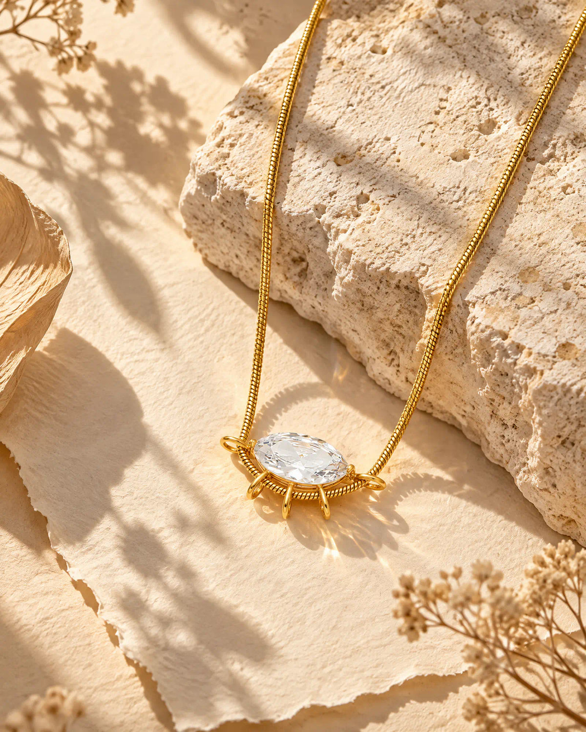 Wearlumi Sunburst Oval Ray Pendant Necklace on natural limestone surface