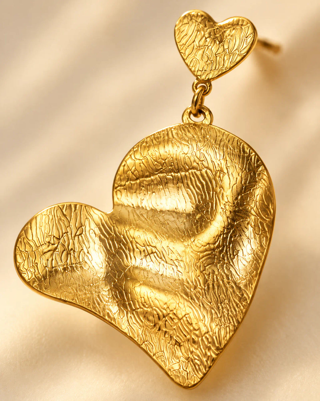 Close-up macro texture of rippled heart drop earring